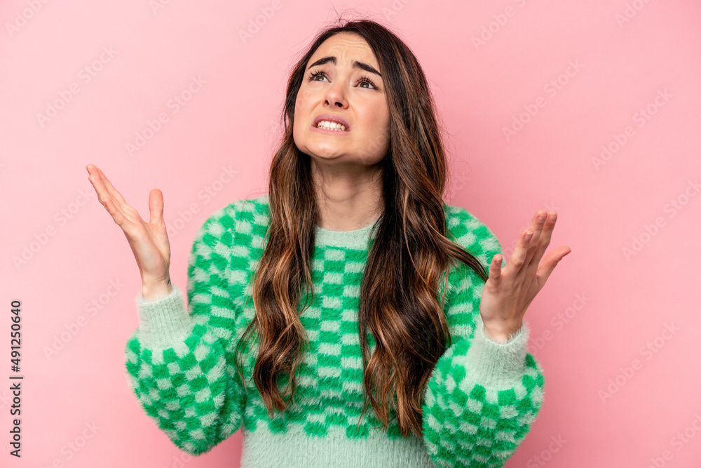 Young caucasian woman isolated on pink background screaming to the sky, looking up, frustrated. Young caucasian woman isolated on pink background screaming to the sky, looking up, frustrated.
