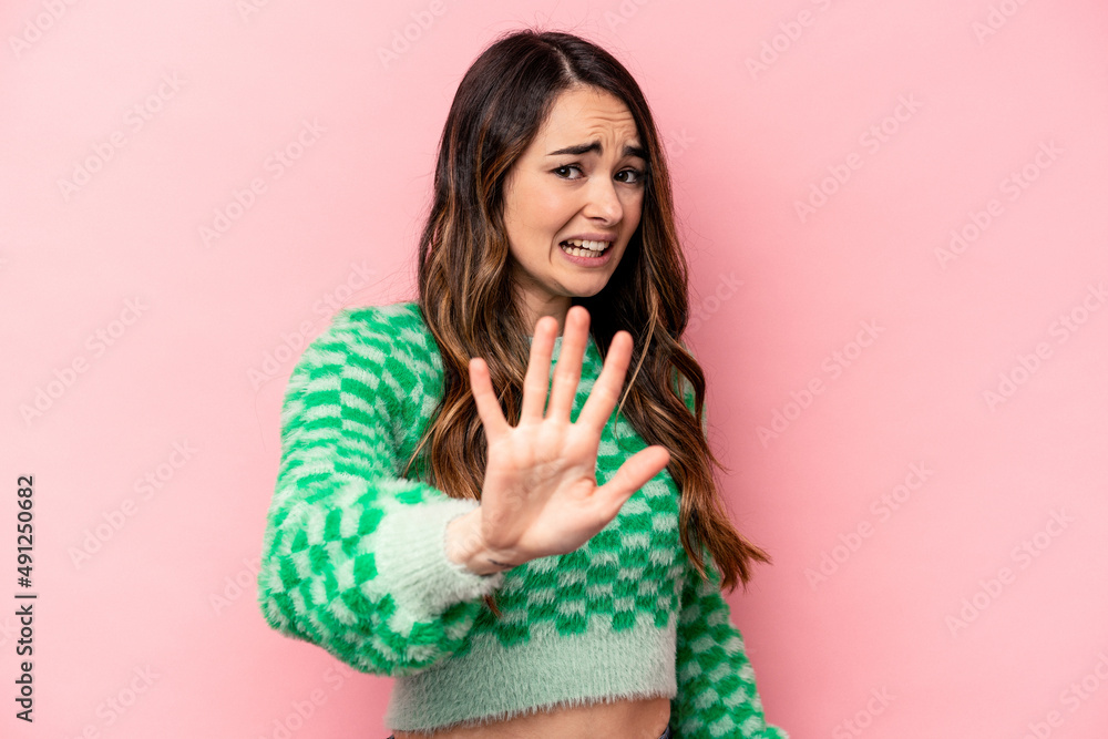 Young caucasian woman isolated on pink background being shocked due to an imminent danger Young caucasian woman isolated on pink background being shocked due to an imminent danger