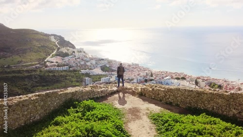 A man looking over the city. Standing in the Ancient old castle.  photo