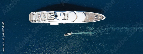 Aerial drone ultra wide panoramic photo of luxury yacht with wooden deck anchored in Mediterranean open ocean deep blue bay © aerial-drone