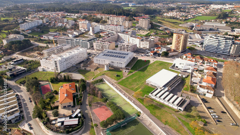 Santo Tirso, Portugal - January 1, 2022: DRONE AERIAL VIEW - The Pavilhão Desportivo Municipal (Municipal Sports Pavilion) and The Piscina Municipal (Swimming Pool). Municipal Sports Complex.