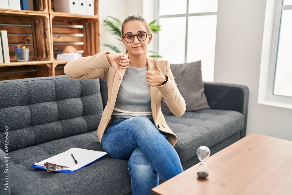 Young woman working at consultation office doing thumbs up and down, disagreement and agreement expression. crazy conflict Young woman working at consultation office doing thumbs up and down, disagreement and agreement expression. crazy conflict