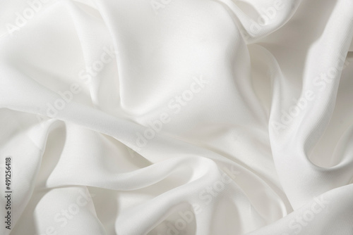 Wrinkled silky luxurous textile. Smoothy satin drapery photo