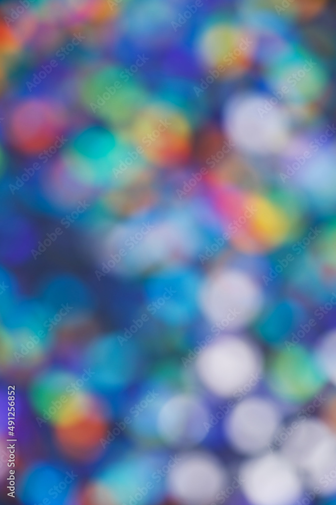 Abstract bokeh background of blurry multicolored light spots.