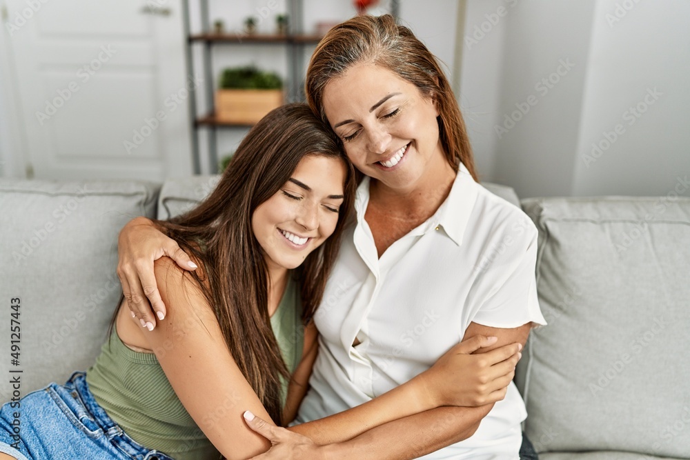 Mother and daughter smiling confident and hugging each other sitting on sofa at home Mother and daughter smiling confident and hugging each other sitting on sofa at home