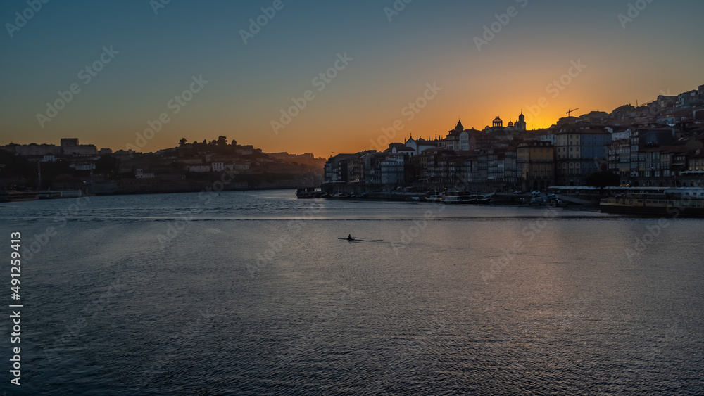 Porto city centre from across the Douro river during sunset city skyline