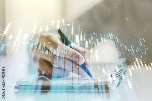 Double exposure of abstract creative financial diagram with hand writing in notebook on background, banking and accounting concept