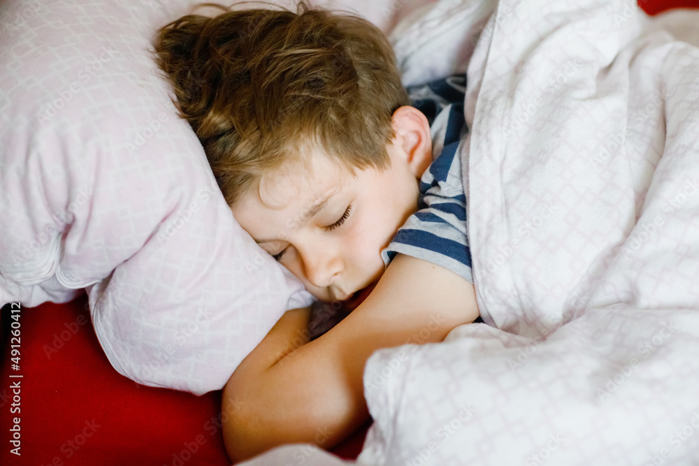Preteen kid boy sleeping in bed. School child dreaming. Tired teenager sleep. Preteen kid boy sleeping in bed. School child dreaming. Tired teenager sleep.