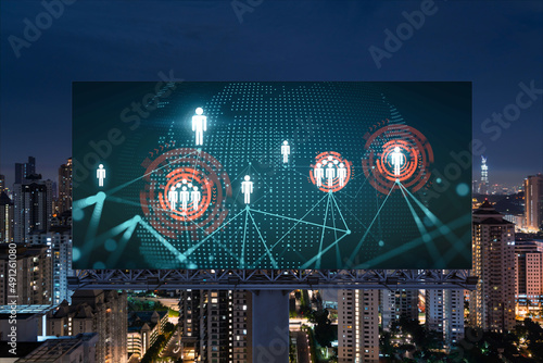World planet Earth map hologram and social media icons on billboard over night panoramic city view of Kuala Lumpur, Malaysia, Asia. Networking and establishing new connections between people. Globe photo