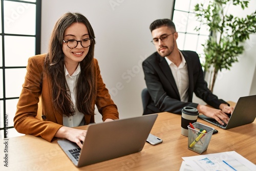 Fotografie Hispanic business worker working and spying partner at the office