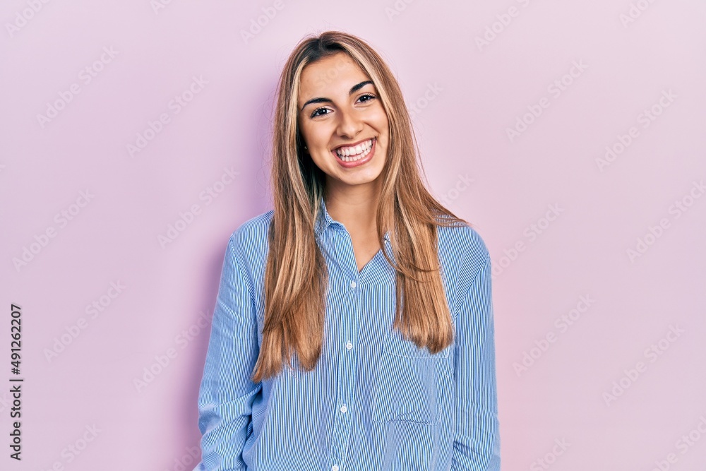 Fototapeta premium Beautiful hispanic woman wearing casual shirt with a happy and cool smile on face. lucky person.