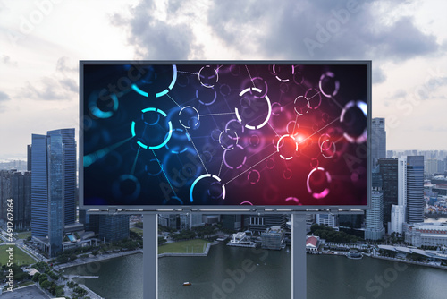 Glowing hologram of technological process on billboard, aerial panoramic cityscape of Singapore at sunset. The largest innovative hub of tech services in Southeast Asia.