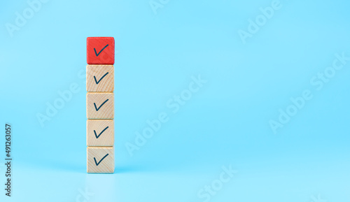 Checklist concept, Check mark on wooden cubes, copy space © Worawut