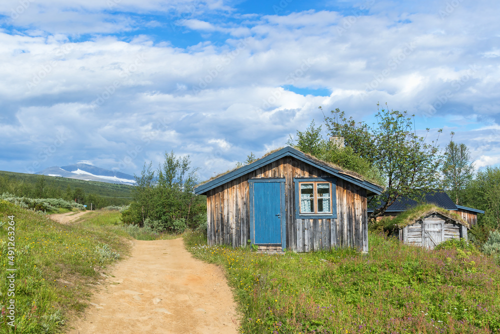 Mountain cabin at a footpath in the mountains Mountain cabin at a footpath in the mountains