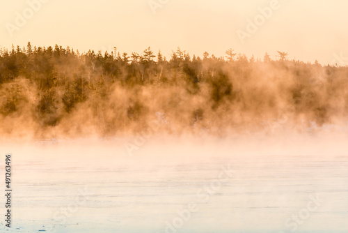 morning fog over frozen sea bed and islands