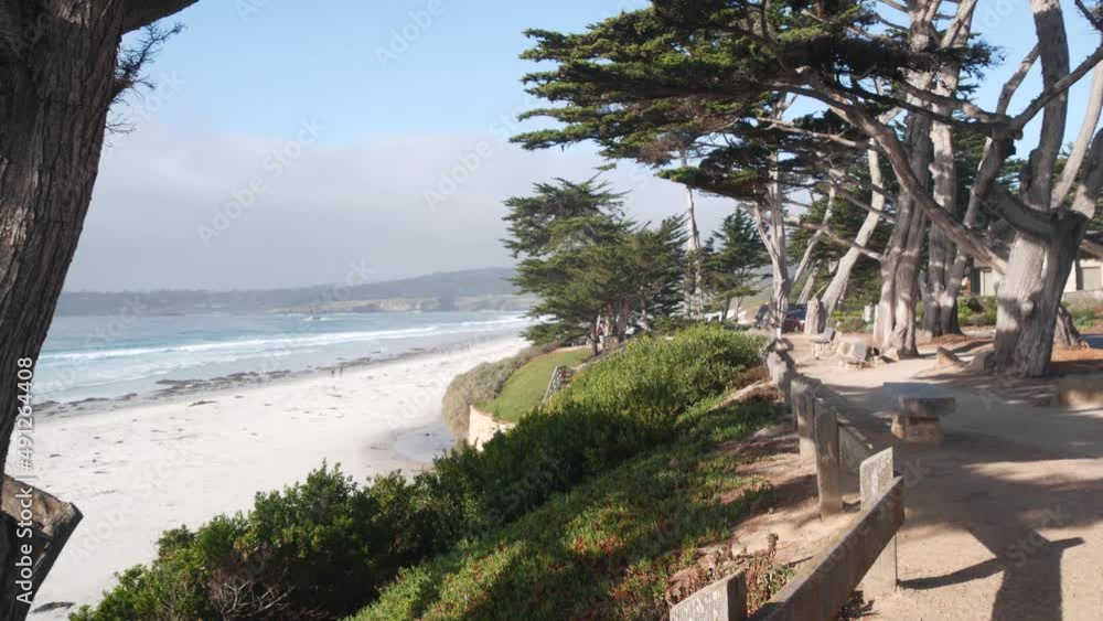 Promenade path, walkway, trail or footpath, ocean sandy beach in Carmel, Monterey, California coast USA. Sea water waves crashing on shore. Waterfront beachfront pine cypress trees. Pathway or footway Promenade path, walkway, trail or footpath, ocean sandy beach in Carmel, Monterey, California coast USA. Sea water waves crashing on shore. Waterfront beachfront pine cypress trees. Pathway or footway