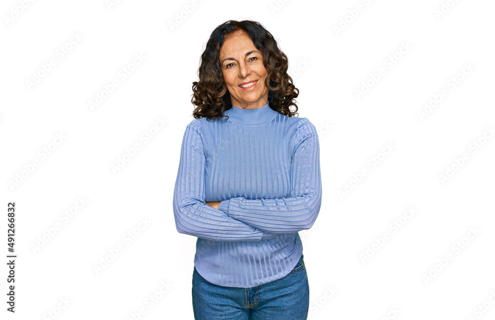 Middle age hispanic woman wearing casual clothes happy face smiling with crossed arms looking at the camera. positive person. Middle age hispanic woman wearing casual clothes happy face smiling with crossed arms looking at the camera. positive person.