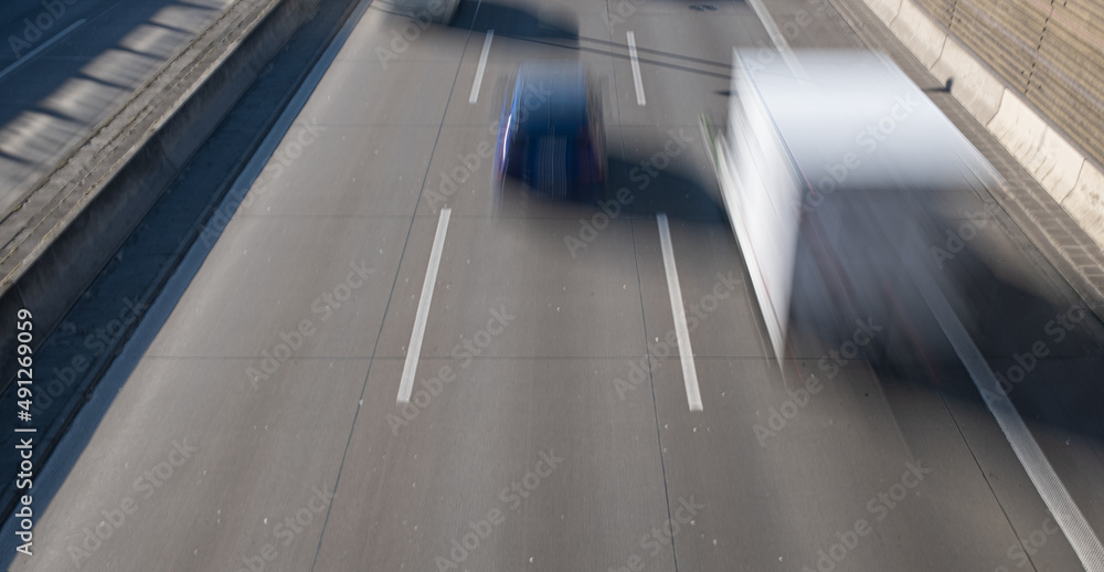 traffic on a German autobahn. View from a bridge to the highway with motion blurred vehicles. 