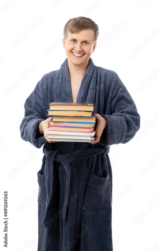 portrait of a man in a gray terry bathrobe. man holds many books and smiles, read a book, relax on a day off, on vacation, after work, quarantine. better at home, stay home. isolated. portrait of a man in a gray terry bathrobe. man holds many books and smiles, read a book, relax on a day off, on vacation, after work, quarantine. better at home, stay home. isolated.