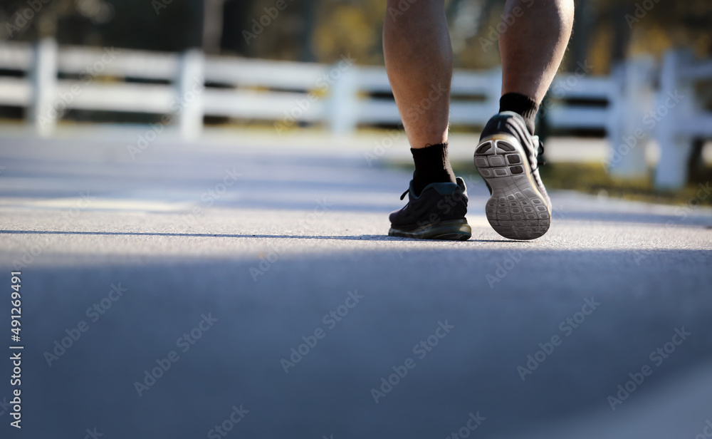 Naklejka premium Low angle view of senior man walking in park.Healthly concept.