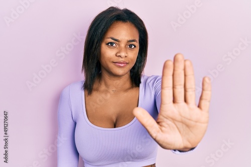 Wallpaper Mural Young african american girl wearing casual clothes doing stop sing with palm of the hand. warning expression with negative and serious gesture on the face. Torontodigital.ca