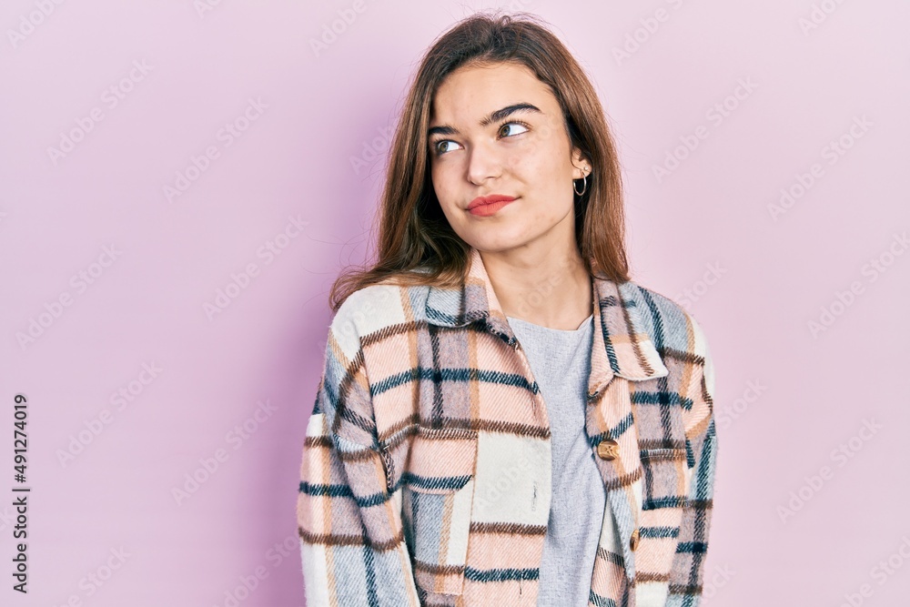 Young caucasian girl wearing casual clothes smiling looking to the side and staring away thinking. Young caucasian girl wearing casual clothes smiling looking to the side and staring away thinking.