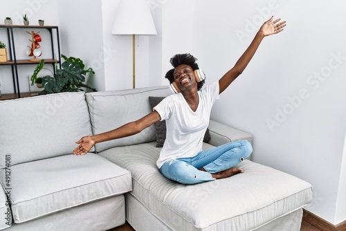 Young african american woman smiling confident listening to music at home