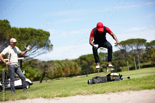 If you think playing is hard try losing. Shot of a frustrated golfer jumping on his golf bag.