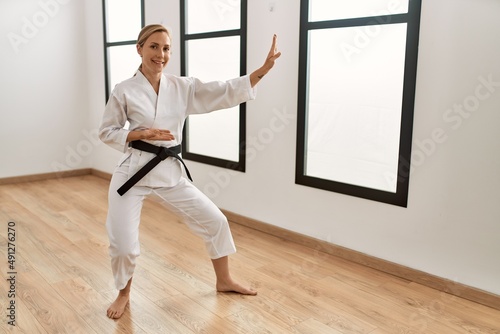Young caucasian woman smiling confident training karate at sport center