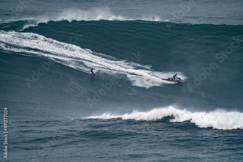 Photography Professional surfer releasing the tow rope that his partner is dragging on the j