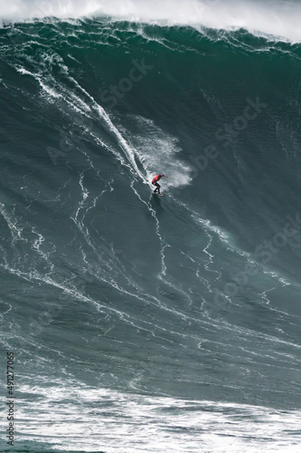 Photography Professional athlete surfing a giant wave.