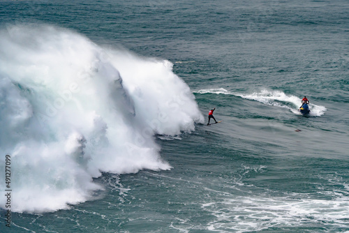 Canvas Print Professional athlete surfing a giant wave.