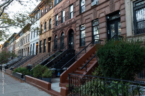 Row of Colorful Old Brownstone Homes in Prospect Heights Brooklyn along a Sidewalk during Autumn