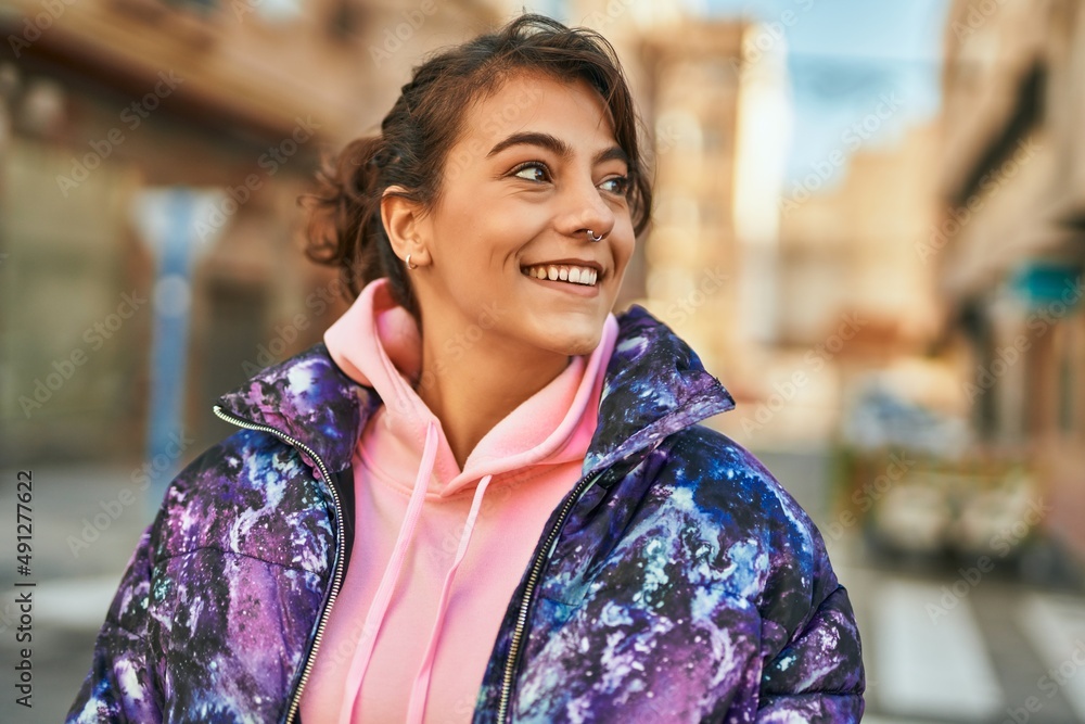 Young hispanic sporty woman smiling happy standing at the city. Young hispanic sporty woman smiling happy standing at the city.