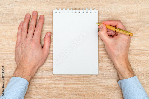 Hand writing in white blank open spiral notebook