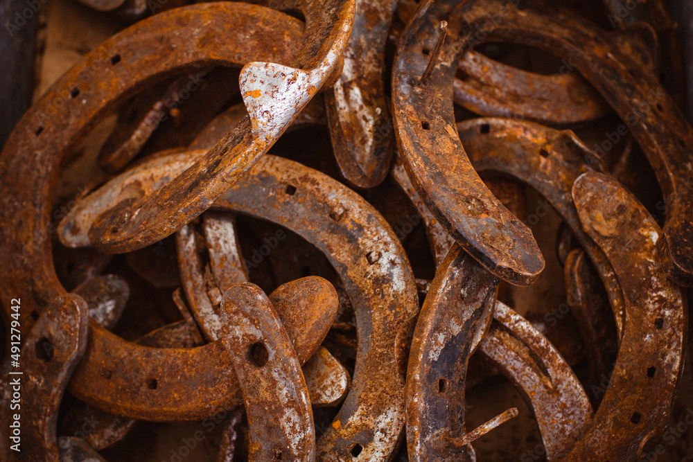 Old used metal horseshoes close up. Good luck symbol. Old used metal horseshoes close up. Good luck symbol.