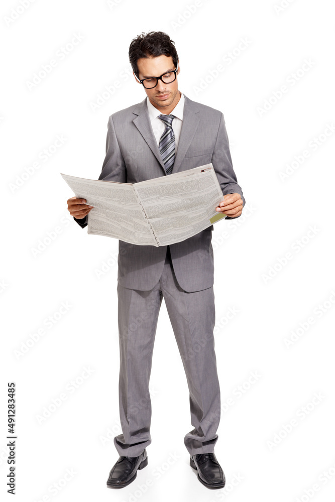 Knowledge is half the battle - Finance. A handsome young financier catching up on the latest stock market news. Knowledge is half the battle - Finance. A handsome young financier catching up on the latest stock market news.