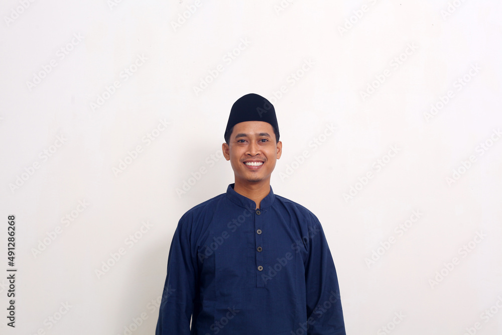 Smile happy face of ordinary Asian man in muslim costume. Concept of charming and positive thinking Smile happy face of ordinary Asian man in muslim costume. Concept of charming and positive thinking