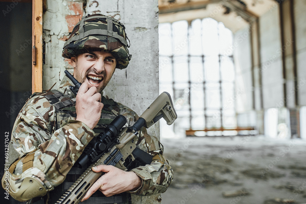 The military speaks rationally and holds a big rifle. The military speaks rationally and holds a big rifle.