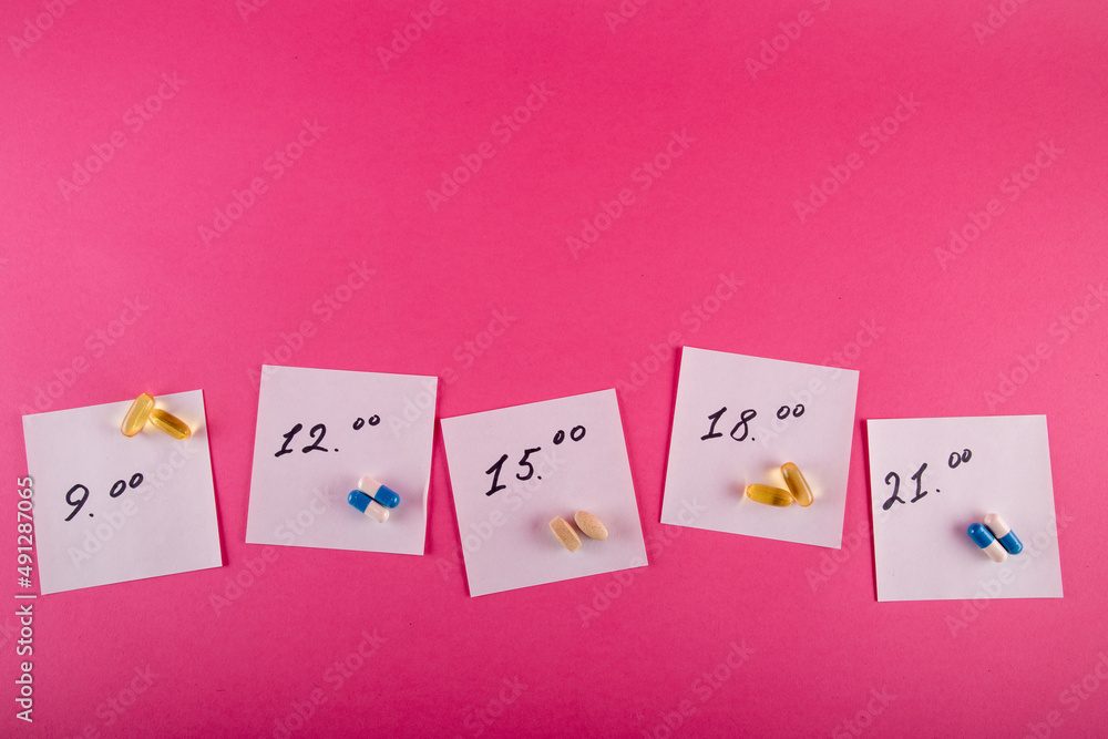 Schedule for taking pills on a pink background, hours for medication Schedule for taking pills on a pink background, hours for medication