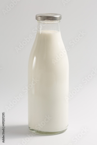 Glass bottle with milk on a white background
