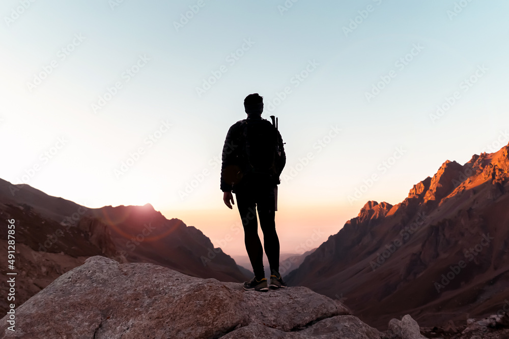 Man is climbing, hiking in the mountains.