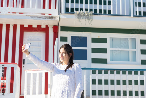 Young woman taking a selfie in Costa Nova, Portugal