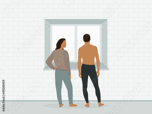 A male character and a female character in home clothes are standing near the window against the background of a brick wall