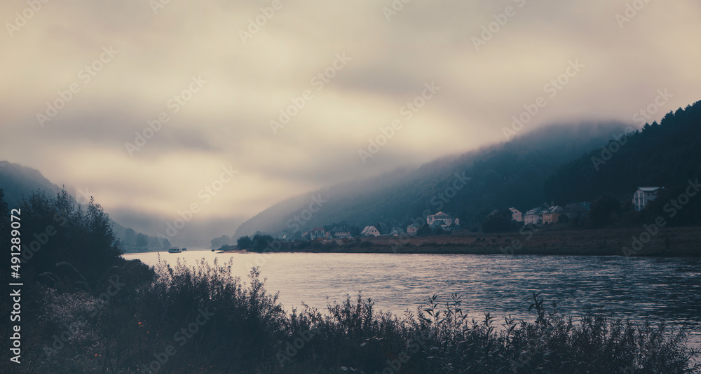 Blick auf die Elbe im Nebel. Wunderschöne Landschaft in in der Sächsischen Schweiz und Bad Schandau mit den berühmten Schrammsteine. Aufgenommen in freier Natur zwischen Felsen und Sandsteinen
