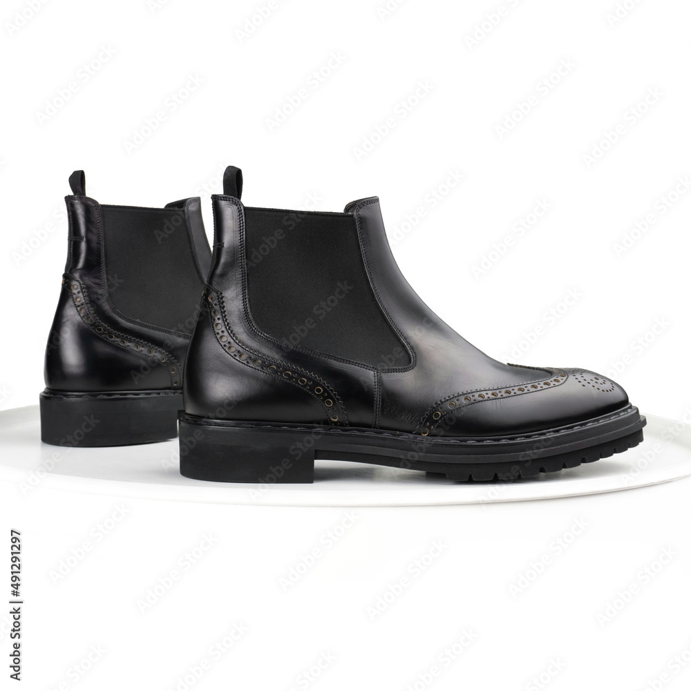Black brogue chelsea boots on a white background