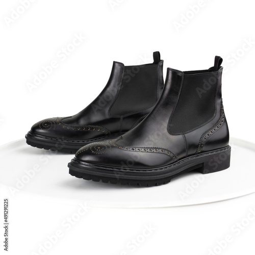 Black brogue chelsea boots on a white background