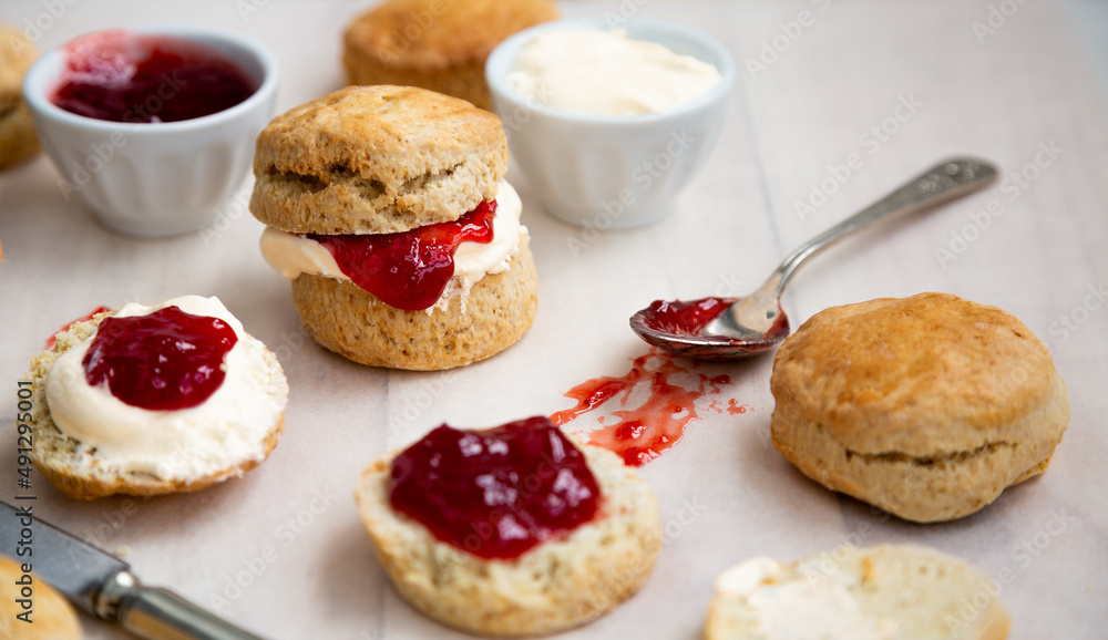 Delicious scones with clotted cream and strawberry jam Delicious scones with clotted cream and strawberry jam