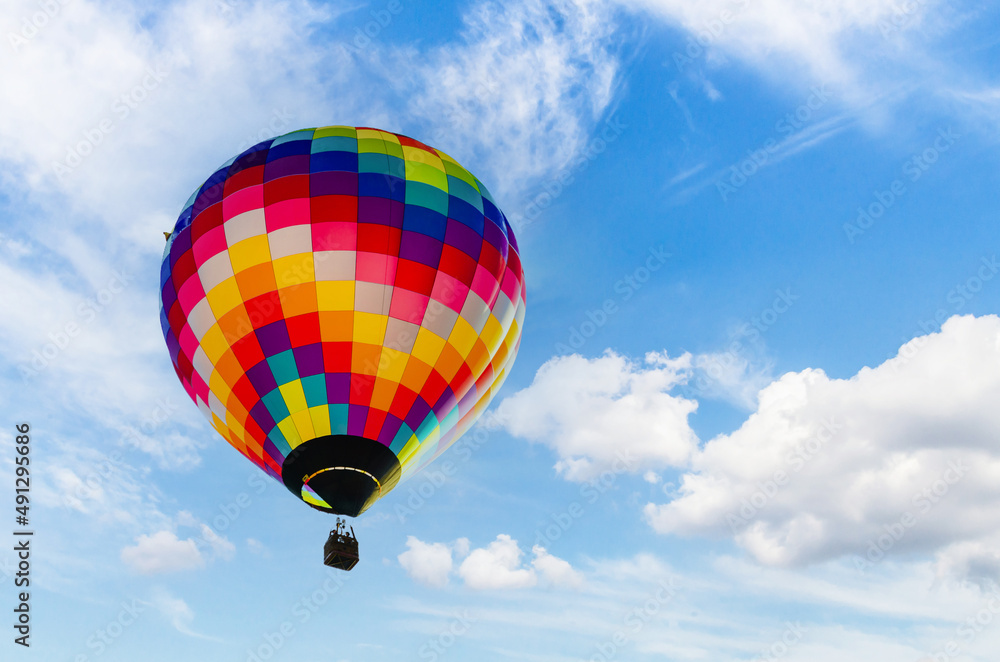 Fototapeta premium Colorful hot air balloon flying over blue sky