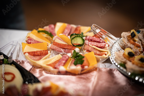 Platter with cheese, cured meat and salami arranged and decorated in an oval shape ready for catering in an event